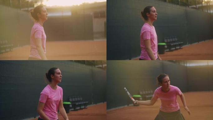 女孩在露天球场上进行网球训练时很累。慢慢接近球，用反手击球