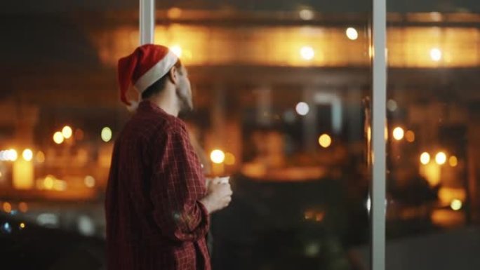 体贴的人在圣诞节透过窗户欣赏风景。