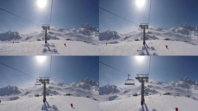 从椅子升降机上拍摄的镜头上升到冬季滑雪场的山顶