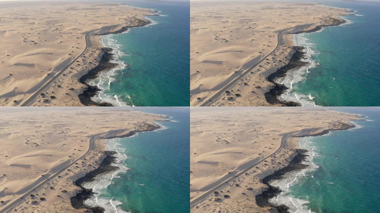 空中无人机拍摄了一条沙质海岸线附近的道路