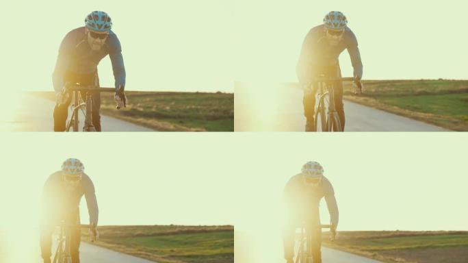 乡村景观培训。男性公路自行车手飞向摄像机。
