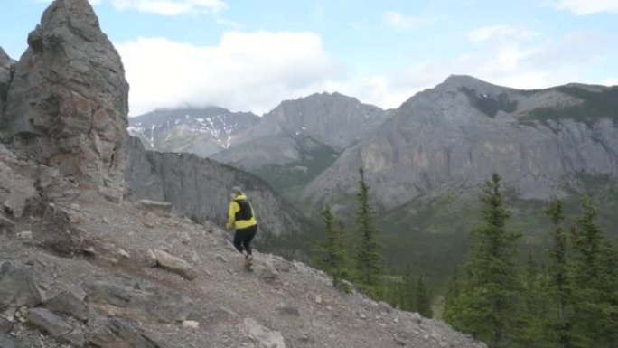 女越野跑运动员沿着山坡上的岩石路线行驶