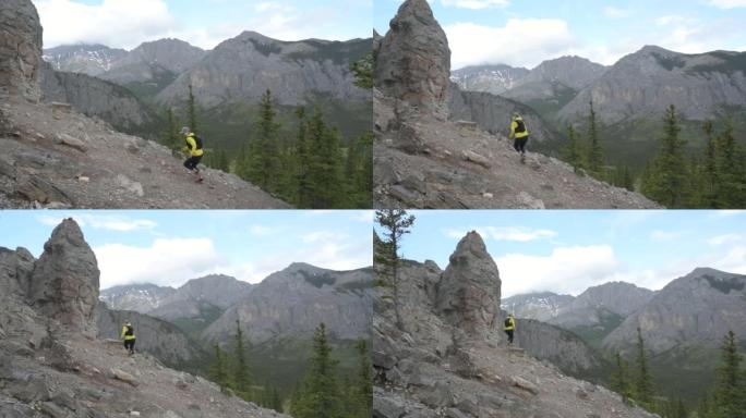 女越野跑运动员沿着山坡上的岩石路线行驶