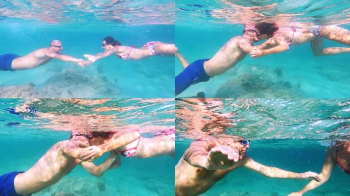 夏天在海里浮潜。夫妇的水下之吻。