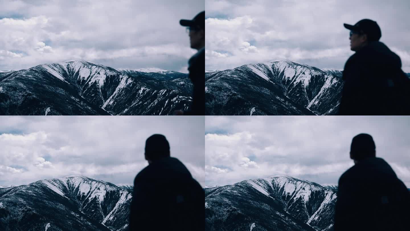 【4K】男子行走在雪山顶上