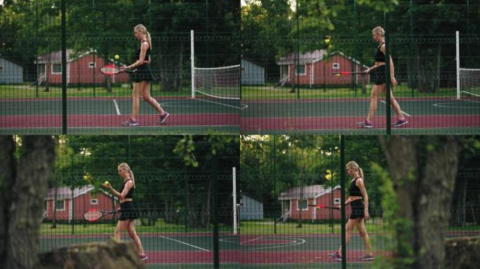 年轻的女网球运动员正在球场上行走，并通过球拍，锻炼和训练来弹跳球。