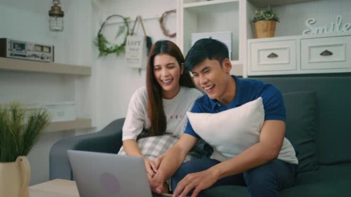 幸福的年轻夫妇使用笔记本电脑进行互联网购买