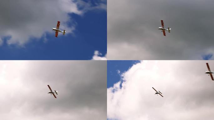 经典的轻型螺旋桨飞机在阳光明媚的蓝天上飞行，白云