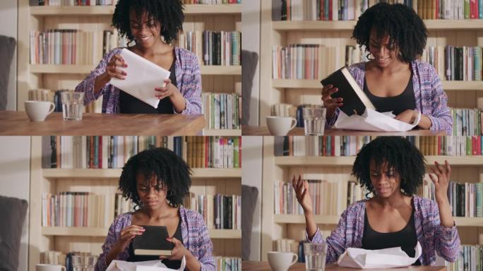 激动的非洲族裔妇女用等待的书打开包裹