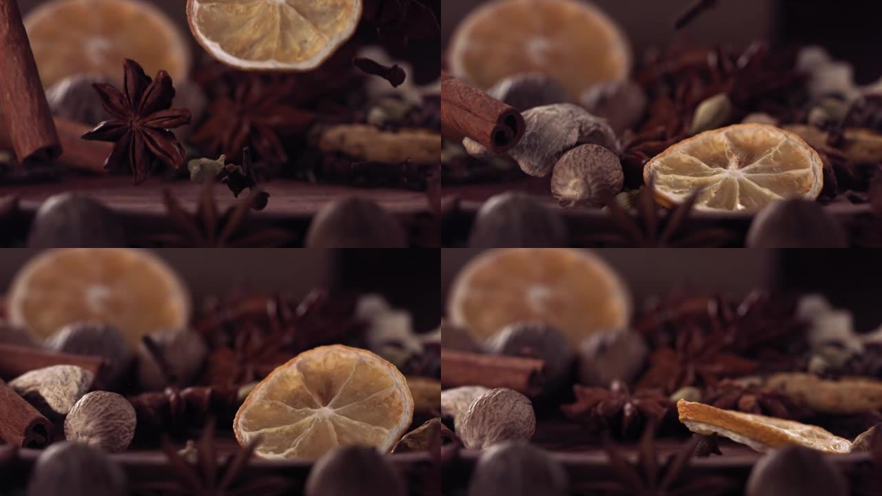 柠檬片和不同的香料落在木头上。慢动作