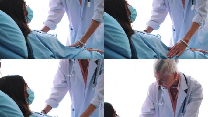 高级医生躺在医院的床上与女性患者交谈。