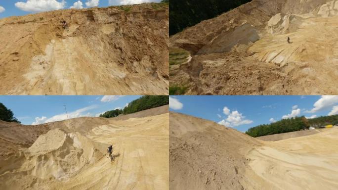 用赛车无人机拍摄沙雷。空而平坦的地形覆盖着黄沙和heacy机械步道