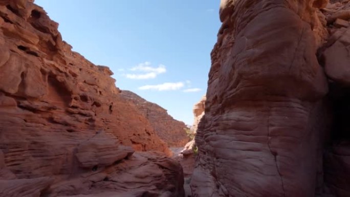 向下倾斜以显示狭窄通道的红色阴影砂岩壁峡谷视图
