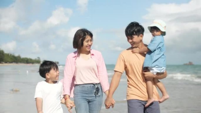 亚洲家庭在沙滩上奔跑着快乐的情感