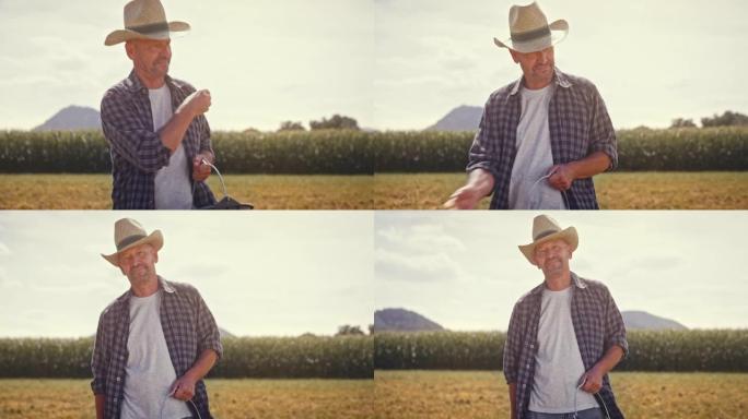 SLO MO肖像，一名中年男性农民在阳光下撒下种子时微笑着
