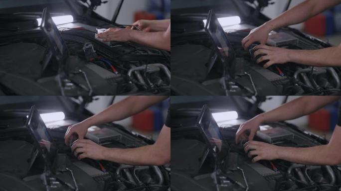 Hands Mechanic使用带有增强现实诊断软件的平板电脑。专家检查汽车以发现内部损坏的组件。男