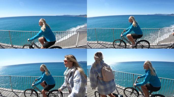 母女俩沿着海滨长廊骑自行车