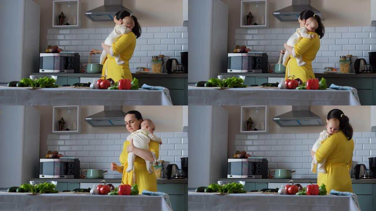 女人在厨房做饭时抱着可爱的婴儿