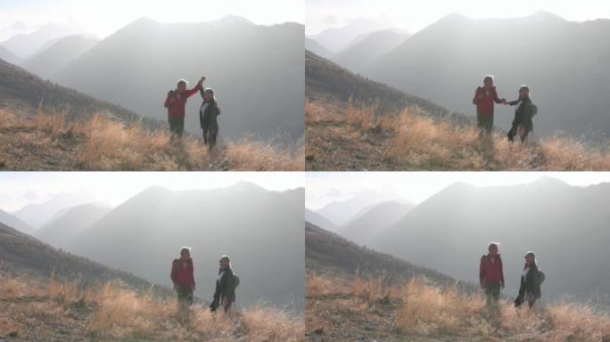 成熟的徒步旅行夫妇在山腰享受时光