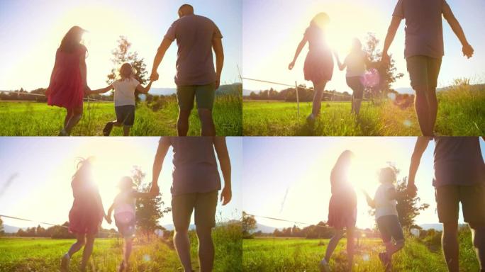 在阳光明媚的日子里，妈妈、爸爸和小女孩牵着手在大自然中散步