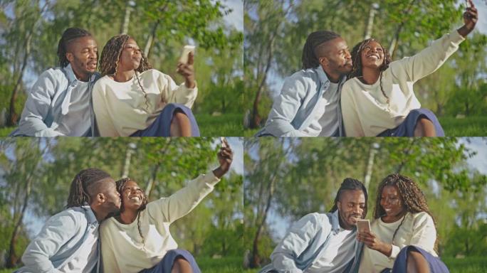 快乐的非洲夫妇在手机上自拍，在公园庆祝周年纪念日
