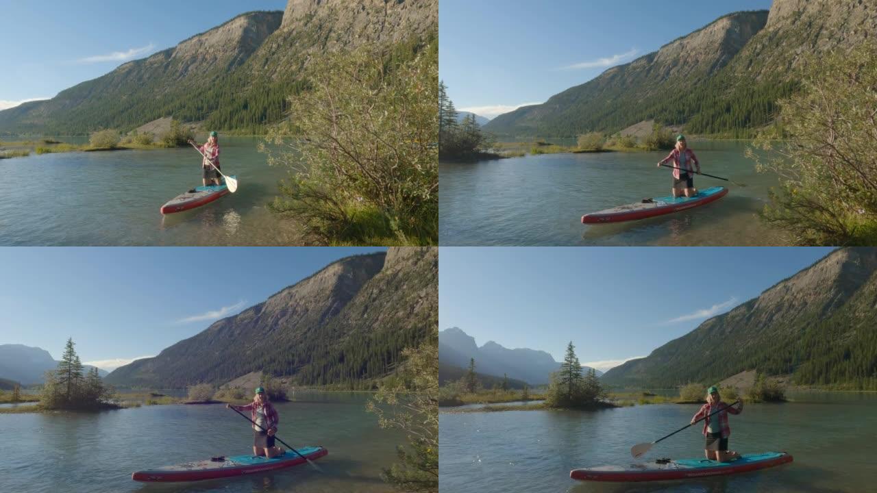 女人在站立的桨板上探索山涧和湖泊 (SUP)