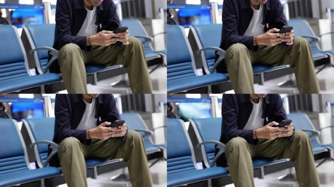 男子在航空公司的登机休息室使用智能手机