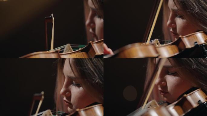 小提琴的特写镜头和年轻女子的脸，音乐家在音乐学校演奏小提琴