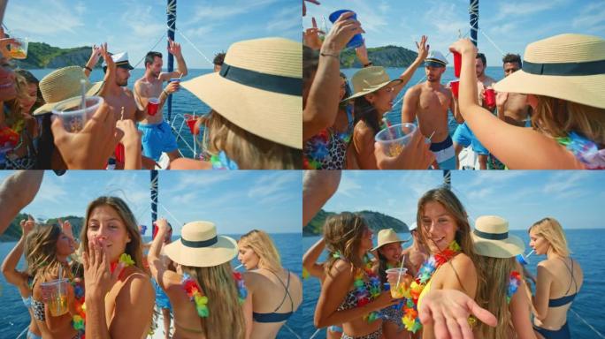 SLO MO女人在游艇上与朋友聚会时向镜头飞吻