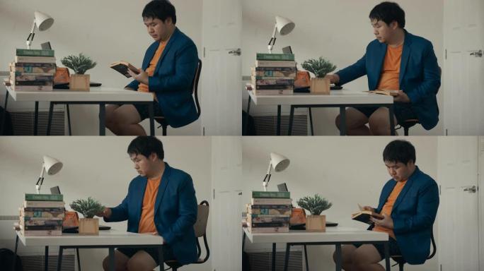 亚洲男子在家庭办公室看书