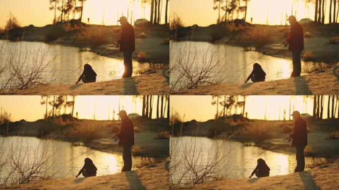 老渔夫和小男孩在湖岸或河边消磨时光，家庭在日落时分钓鱼