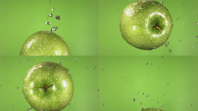绿色背景下的绿色苹果在慢动作中的飞行