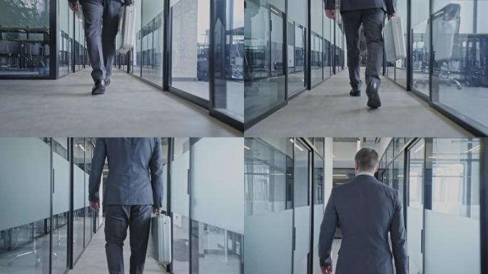 穿着西装的男人走着空荡荡的办公室走廊，与合作伙伴会面