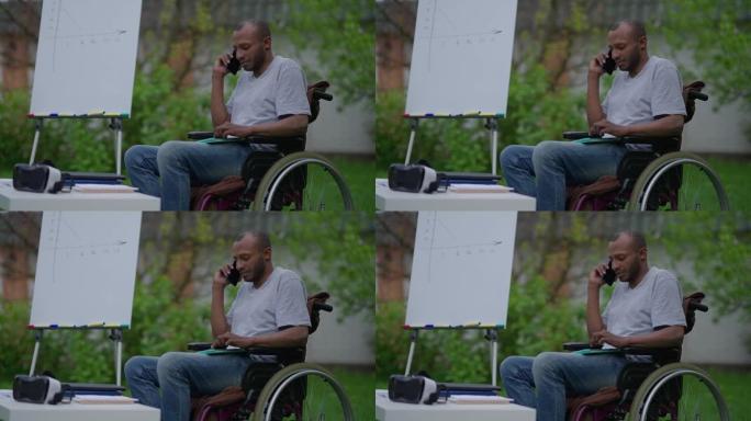 坐在轮椅上自信的残疾专家坐在户外夏季花园的电话上讨论商业想法的侧视图。严肃的职业非裔美国残疾人说话。