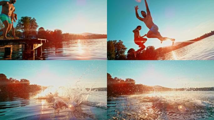 SLO MO两个年轻人在日落时跳入湖中