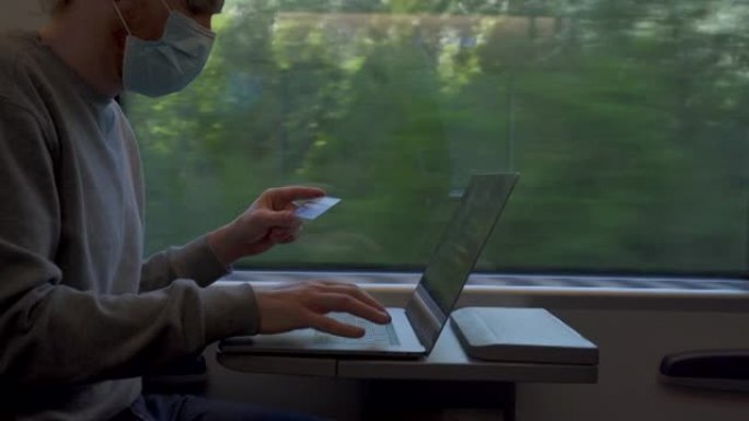 男子乘火车旅行时使用笔记本电脑付款