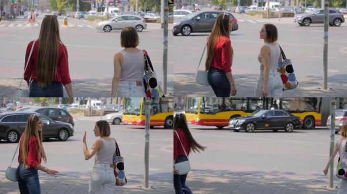 年轻女性朋友说再见，在街道人行道上的城市里分开走