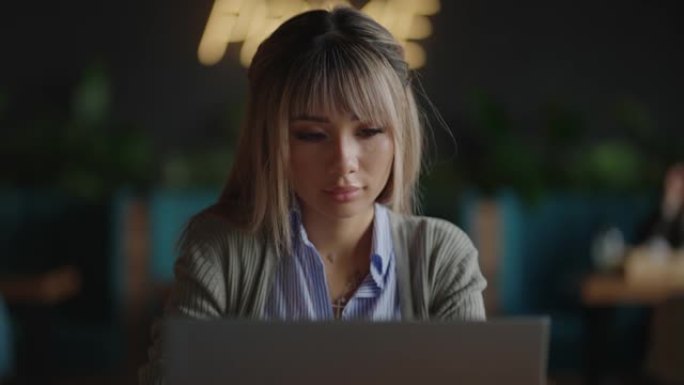 亚洲学生在校园图书馆用笔记本电脑远程工作