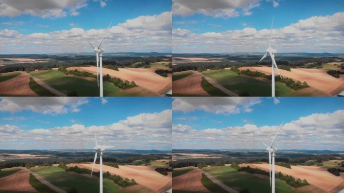 风车与巨大的旋转叶片对抗蓝天。风力发电机涡轮。绿色和可再生能源概念。环境保护。替代能源