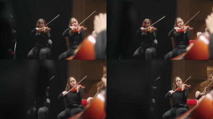 小乐团的音乐会，女小提琴手正在演奏音乐，年轻的专业音乐家