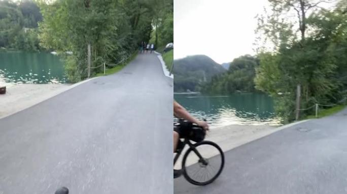 骑自行车的人沿着湖岸骑行