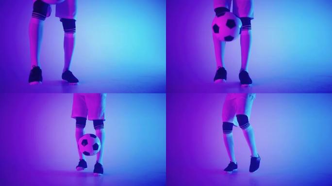 保持有才华的足球运动员的uppie技巧，足球靴中的脚特写镜头和工作室中的球