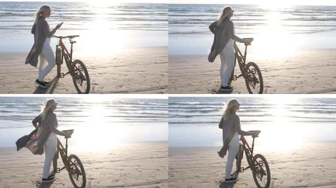 女人在空旷的海滩上推自行车
