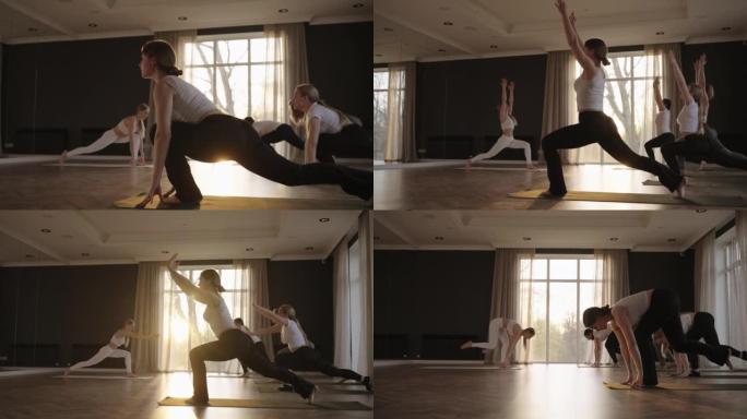 日出时在工作室练习战士姿势的健康成熟女性瑜伽课享受早晨体育锻炼