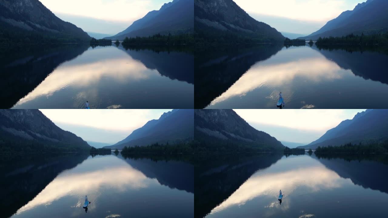 站立桨寄宿生 (SUP) 的鸟瞰图在湖上享受宁静的时光