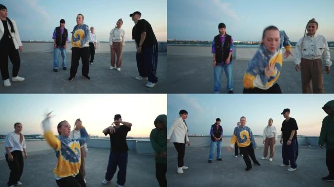 活跃的年轻女子在屋顶上跳舞嘻哈和断裂舞，街头舞者的青年聚会场所