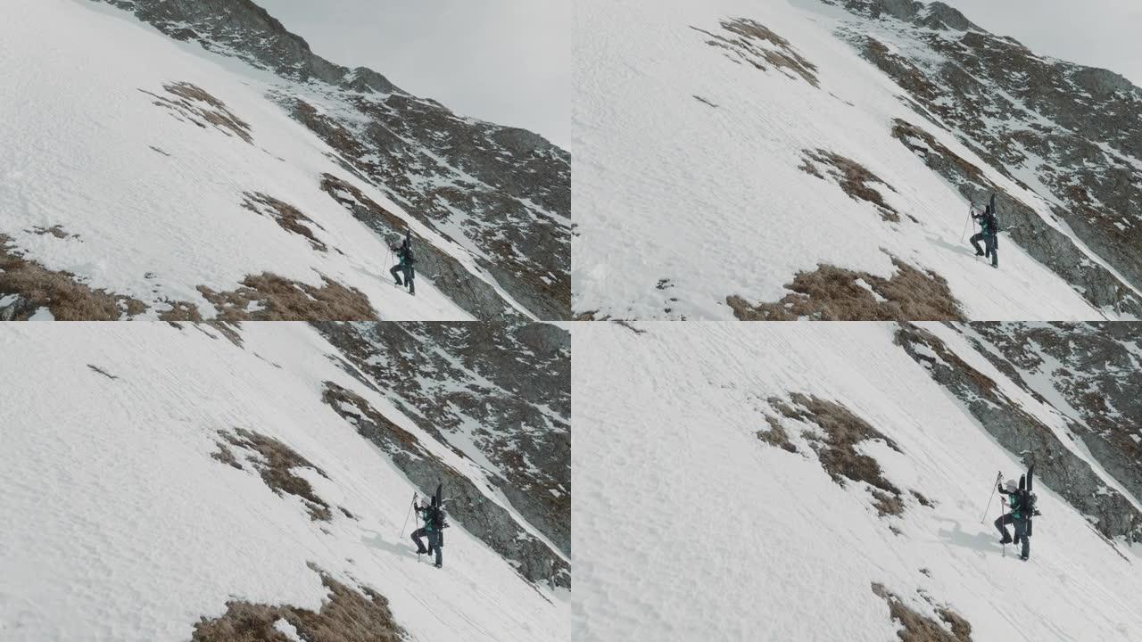 两名滑雪者在雪山上徒步旅行的空中无人机拍摄