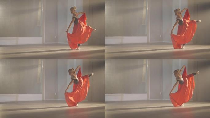 身材苗条的专业芭蕾舞演员在蔓藤花纹的芭蕾舞姿势中，手持猩红色的裙子弯曲。优雅的高加索女芭蕾舞演员在右