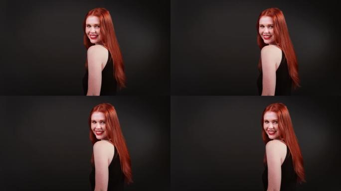 美丽的红发女人，留着健康的长发。用相机调情