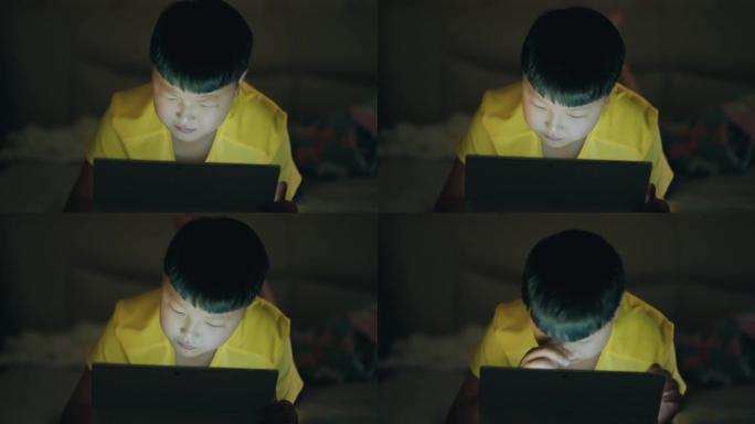 亚洲男孩使用电脑，儿童近视。